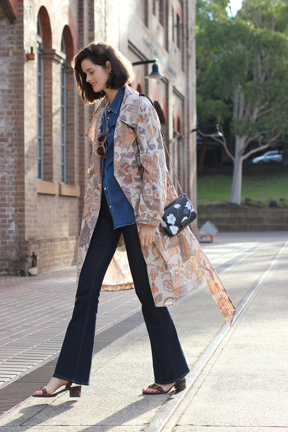 Sydney-Style-Blogger-Chloe-Hill-wearing-Karen-walker-trench-coat-acne-denim-shirt-pared-sunglasses-Alila-floral-print-bag-and-citizens-of-humanity-sculpt-flares-at-carriage-works