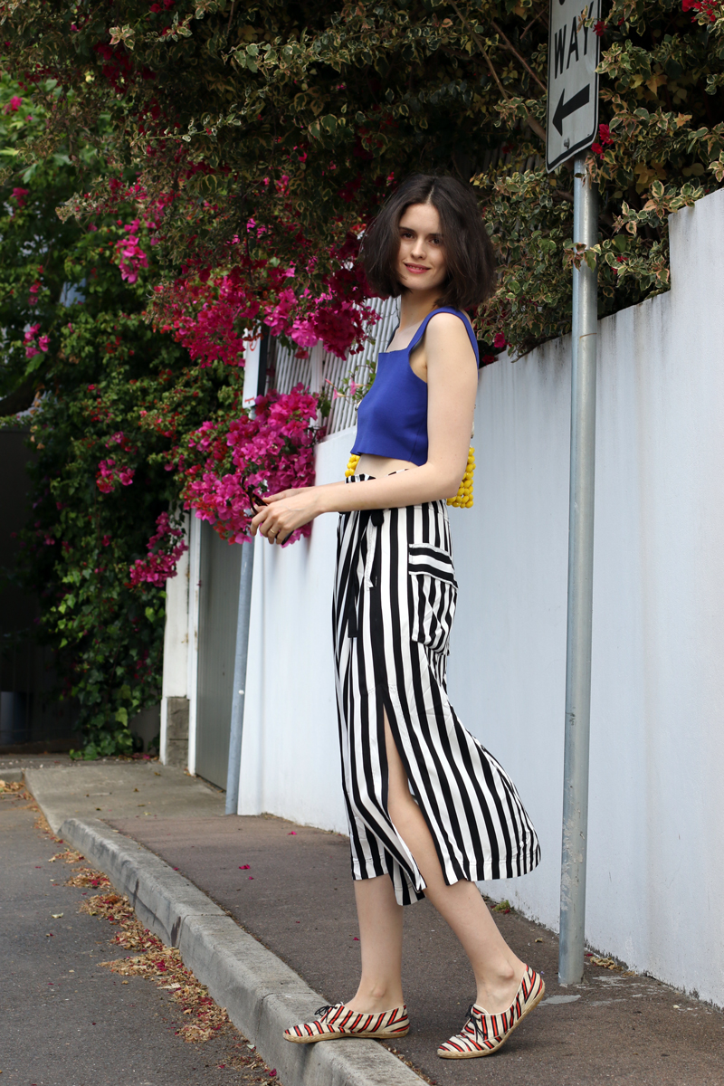 Chloe Hill Wearing Marni blue crop top and beaded bag, Lee Mathews stripe wrap skirt and Tabitha Simmons striped shoes in Paddington