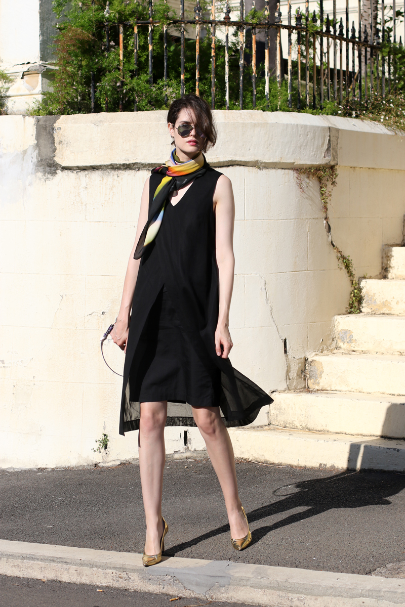 Chloe Hill wearing Gary Bigeni layered black dress, Deadly ponies x len lye rainbow scarf, reflective rayban aviators and gold manolo blahniks