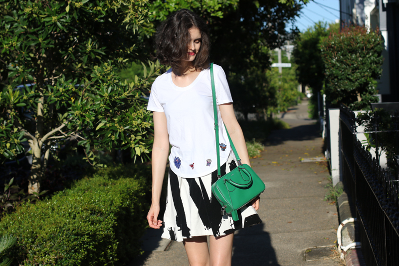 Chloe Hill Wearing Mira Mikati Tshirt from Shopbop, Cocurata skirt and a Bally green bag on the Streets of Sydney