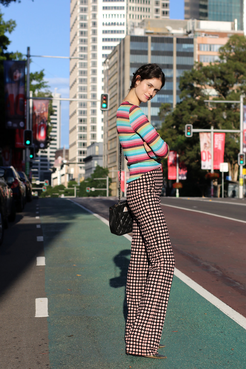 Chloe Hill wearing a Dolce and Gabbana striped cardigan, Bottega Veneta spot print pants and a Chanel quilted shoulder bag on the Streets of Sydney Australia