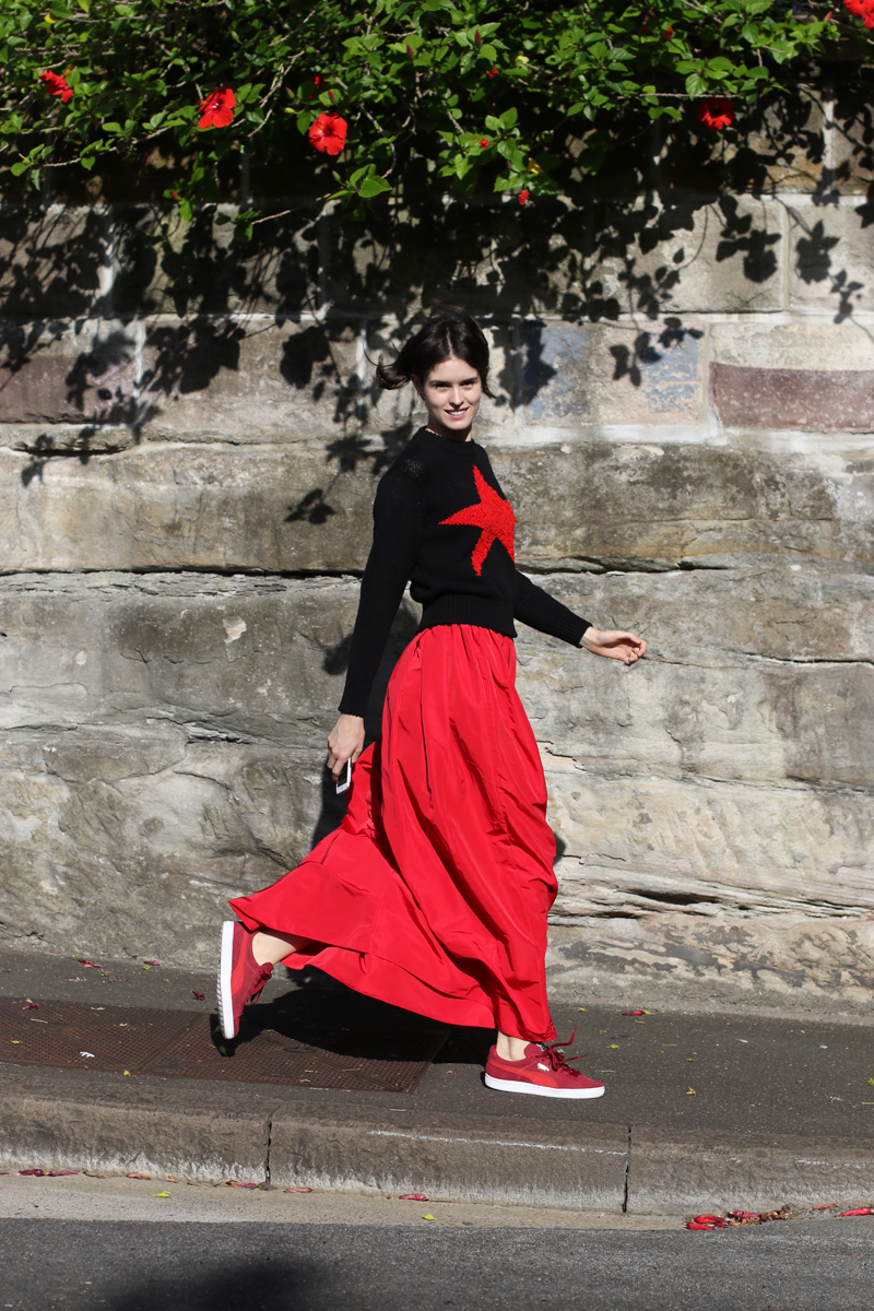 Sydney stylist Chloe Hill in Diesel star jumper, khalo red skirt and puma suede shoes