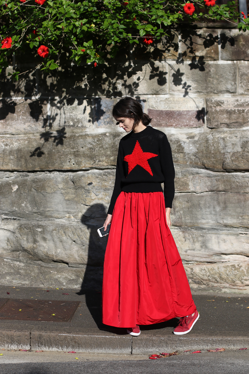 Sydney stylist Chloe Hill in Diesel star jumper, khalo red skirt and puma suede shoes